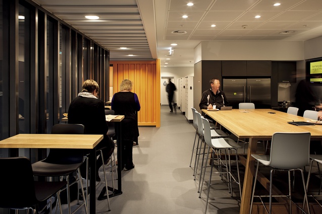 The café space is also an alternative work area. Lockers in the background are provided for staff to store belongings.