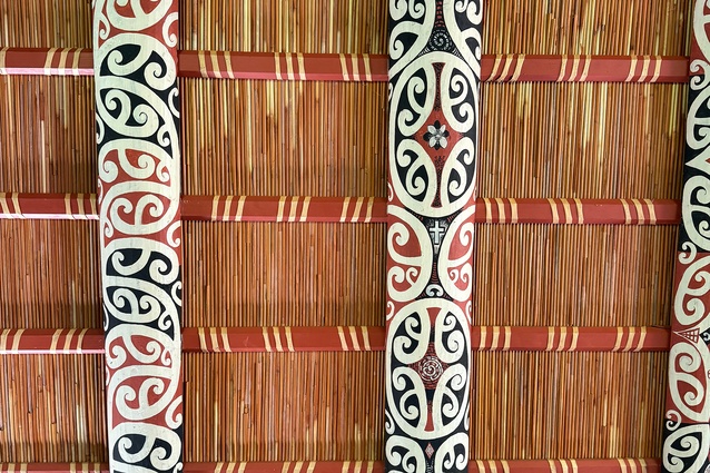 Kōwhaiwhai (painted scroll ornamentation) on the internal rafters of Takipū Marae.