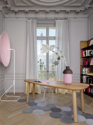Furniture includes the Philip Arctander's 'Clam" chair (circa 1944), desk by Jasper Morrison, vase from Hella Jongerius and Parabola wall lighting designed by Pierre Charpin.