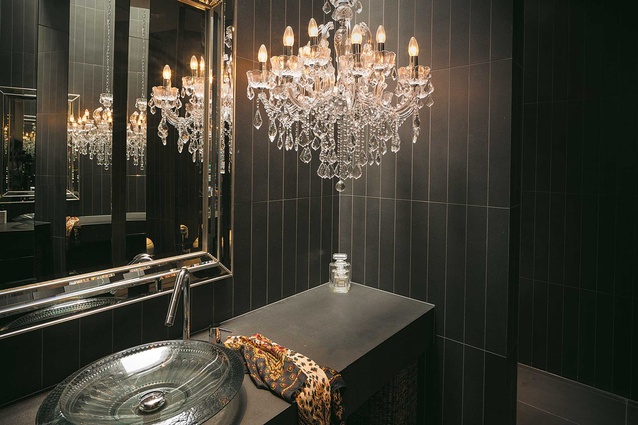 The powder room, with venetian glass vanity bowl by Kohler, on a basalt plinth and wall by Island Stone.