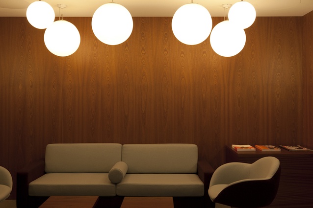 Simple furniture referenceing mid-century design creates a meeting nook for staff. 