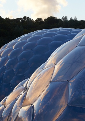 Eden Project, built in 2001. The lightweight ETFE panels naturally adapt to the local topography. The biomes were partially inspired by Buckminster Fuller’s geodesic designs.