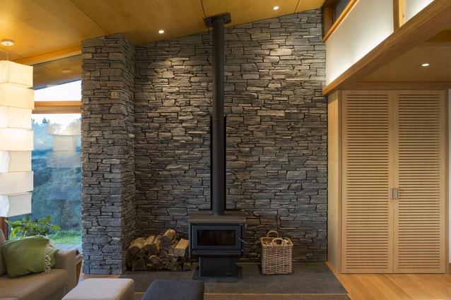 Stone panels are placed throughout the home to block the view of power lines to the north. 
