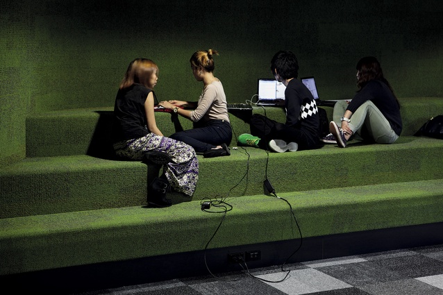 Carpeted bleachers in an area that can be curtained off to form an impromptu learning space.