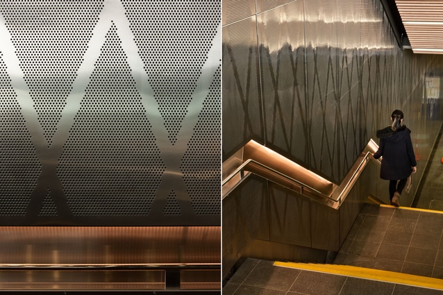 A recessed handrail and a diamond-detailed acoustic wall accompany visitors to the train station in the buildings basement. 