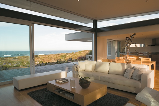 The open format living area opens up to a small deck, with the dunes and ocean beyond.