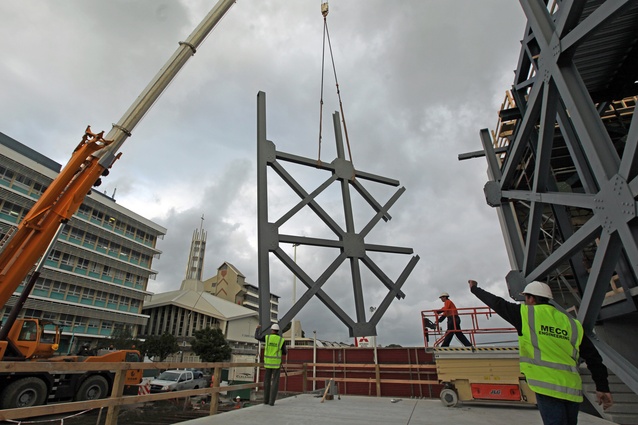 Structural steel components are craned into position. 
