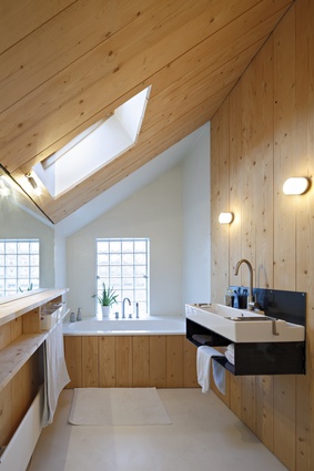 The timber-finished bathroom glows with natural light.
