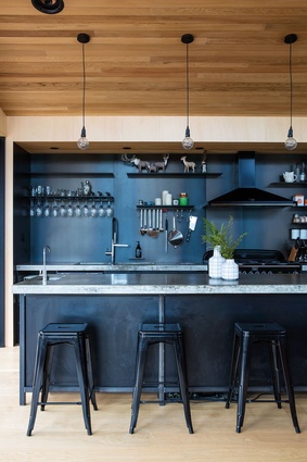 Lot 101: The black kitchen contrasts with the warm timbers.