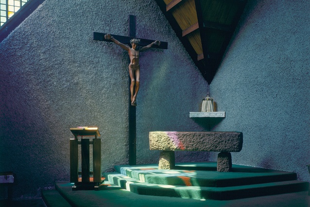 A hand-carved mahogany statue of Christ, by sculptor Jim Allen adorns the wall behind the large stone altar.