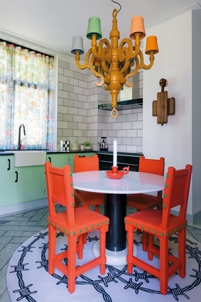 A Lotorosso table by Ettore Sottsass is paired with Studio Job’s Gothic chairs and a Paper pendant light for Moooi.

