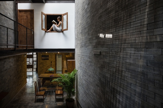 Zen House by H.A, Ho Chi Minh, Vietnam. The apartment was built for Buddhist monks and features a natural palette of dark unrefined brick, bare wood, unpainted cemboard and more.