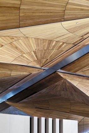 The kauri canopy extends into the intricately patterned ceiling of the northern atrium and main entrance.