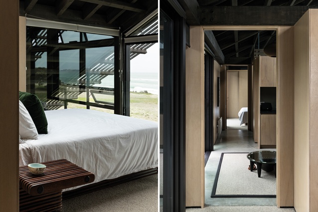 The bed and bedside tables were imported from Fiji and are made of coconut wood; beneath the rafters, the mezzanine level is home to the master suite. Meranti ply walls are crisply detailed in contrast to the band-sawn structural framework.