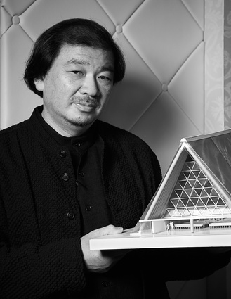 Shigeru Ban holding a model for the Transitional Christ Church cathedral.