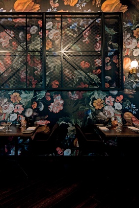 The hotel relies on textures throughout to offer a sense of tactility and warmth to public spaces. A wallpaper based on an 18th-century still-life appears here. 