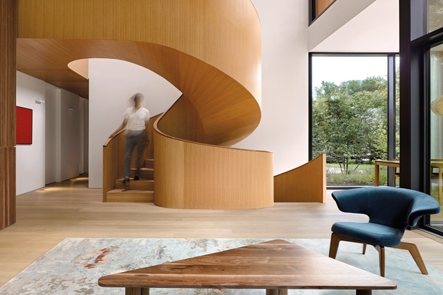 The simple-yet-magnificent timber spiral staircase connects the living room to the second-floor master suite.