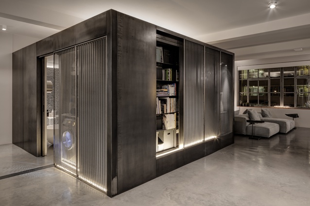 The metallic cube’s sliding mesh panels, cupboards and niches allow each face to fulfil a different purpose.
