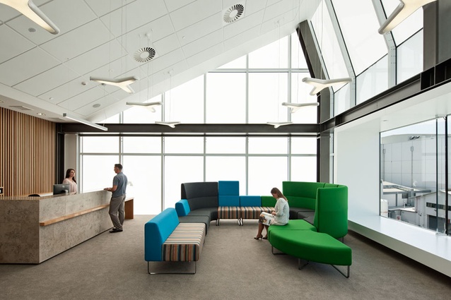 A light and welcoming waiting/ reception space floor features a large box window through which a panorama of the distant hills can be viewed. 