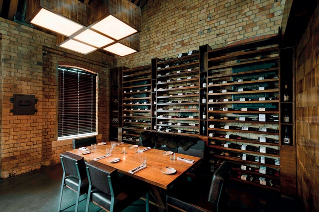 Private dining area with bespoke wine rack. The area can be configured into various iterations, thanks to sliding doors and seating made specifically for this purpose.
