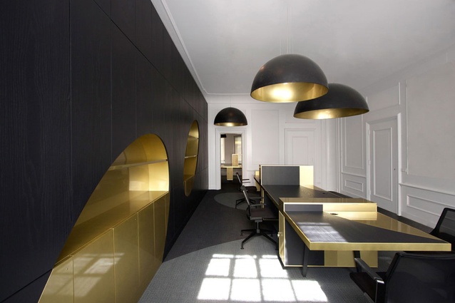 Herengracht office. "Golden and silver ovals shatter through the spaces like golden coins," say the designers. Large round lampshades, spray-painted gold on the inside, seem to cast light and shadow oval marks throughout the whole space.