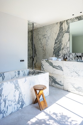 The heavily patterned Arabescatto marble is strikingly used in the kitchen and bathrooms.