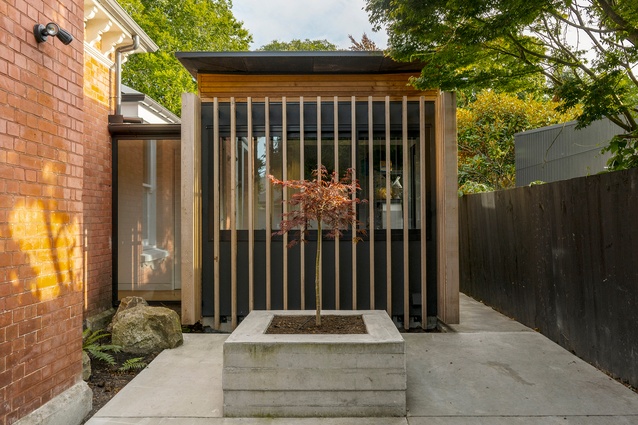 A courtyard at the side of the house, formed by the addition of the garden room.