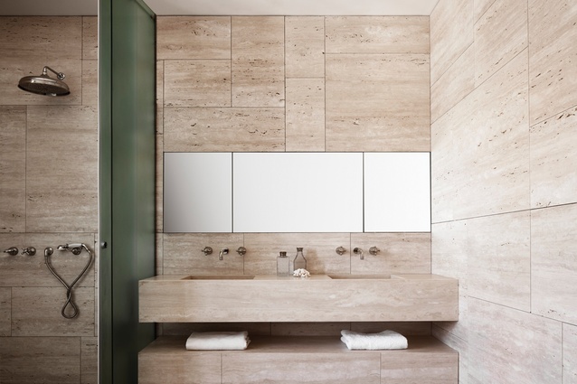 Bathrooms use a light travertine where the pores were left open to give life to the material.
