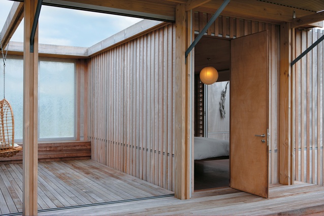 Looking from the deck into the private master bedroom; translucent screens have been used throughout the house to create privacy while admitting light.