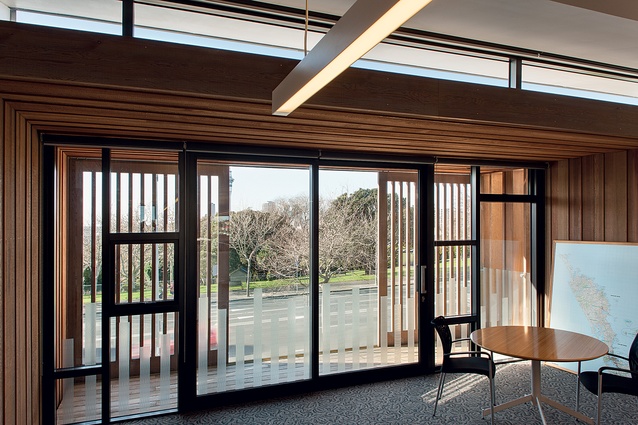 Louvred cedar shading on the balcony matches the unevenly expressed panelling seen throughout the interior.