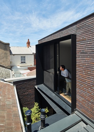 External black steel window surrounds are tapered at angles to block the overlooking of and from neighbours.