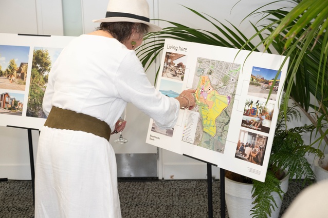 A guest takes a closer look at the Beachlands South masterplan and project vision during the post-ceremony gathering. 