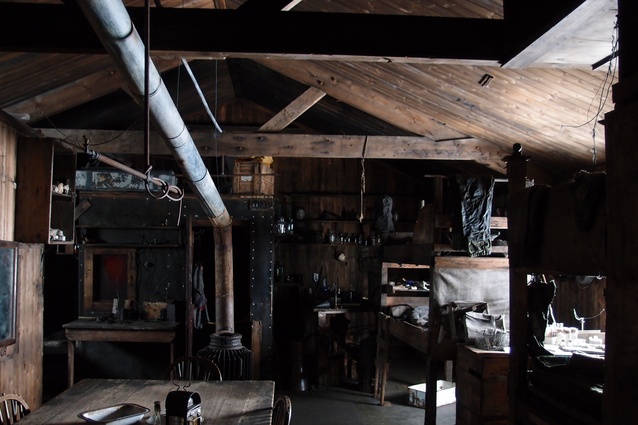An interior view of Scott’s Discovery Hut filled with historic artefacts.