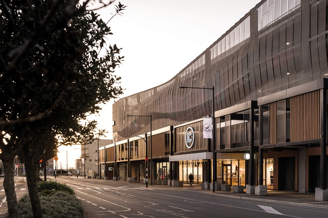 The main Tay Street frontage signals a cooler industrial tone, with the upper-level car park screened in a textured mesh pattern.