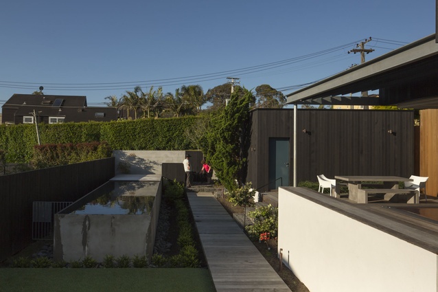 To avoid the use of pool fencing, it is elevated, with a landscaped trench running alongside. 
