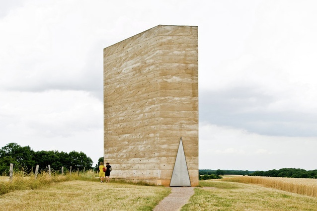 Bruder Klaus Field Chapel, Germany by Peter Zumthor. Concrete was poured on top of a wigwam of 112 treetrunks and then set on fire, leaving behind a hollowed blackened cavity.
