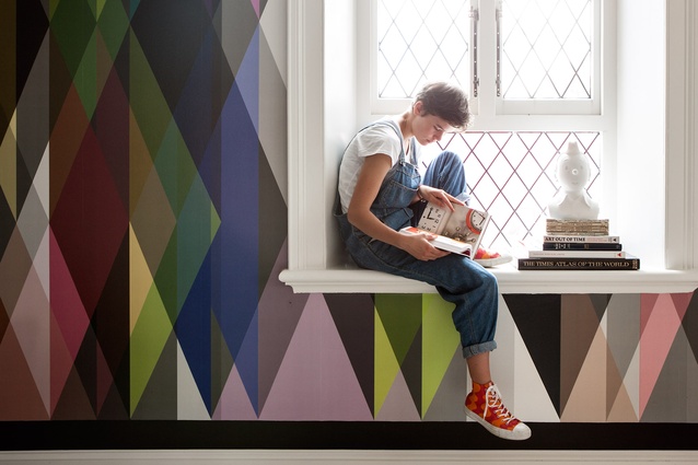 Brighouse's daughter Madeleine reads surrounded by the vibrant wallpaper that started it all.