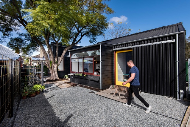 The building is split into two discernible spaces: a weatherboard cottage for living and an adjoining corrugated shed for working.