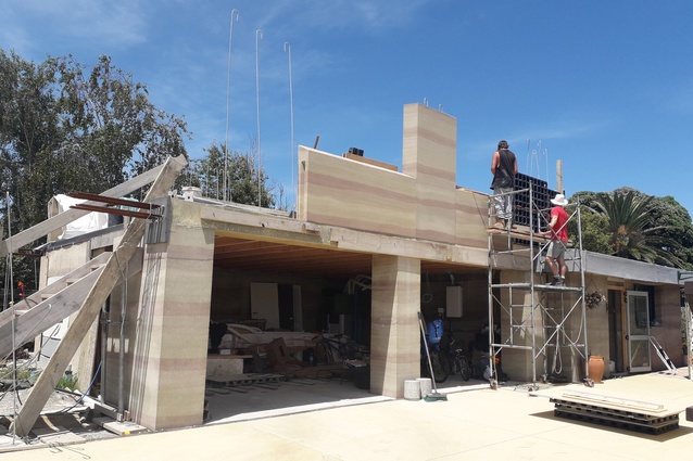 Rammed earth walls going in to The Living House.