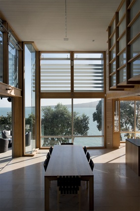 Double-height living and circulation spaces serve to open the interior to the view.