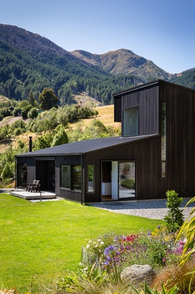 Clad in black cedar, the house sits quietly within its location.