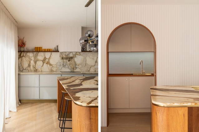 The marble benchtop wraps up onto the splashback. A view through to the scullery, where a vibrant burnt-orange Formica benchtop brings the fun.