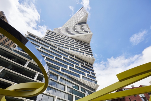 View to tower from podium level framed by public art elements.
