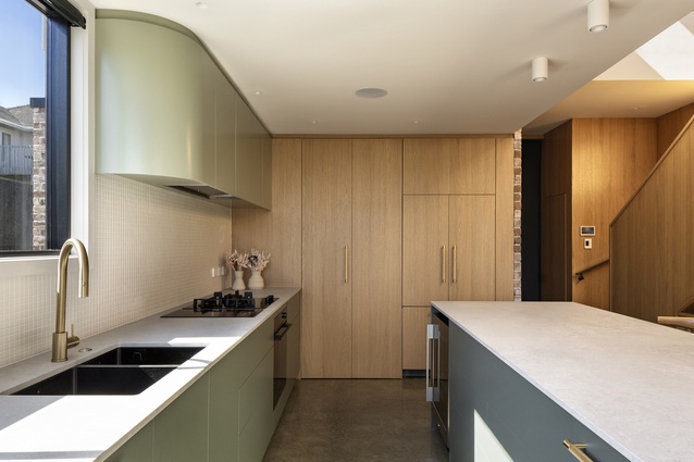 A curved upper cabinet in the kitchen echoes that seen in the brickwork outdoors.