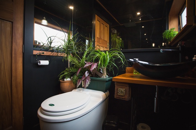 A mix of secondhand finds and lush planting give the bathroom a unique look.