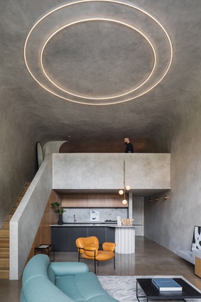 Ambient lighting – an oversized circular ceiling light above the lounge and a pendant light cluster in the kitchen – punctuates the design scheme.
