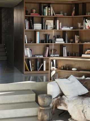 A relaxed bookcase gives the living room a homely, inviting feel.