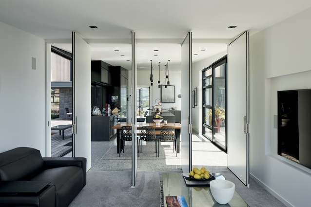 Fold-out doors connect spaces, creating open sight lines between indoors and out.