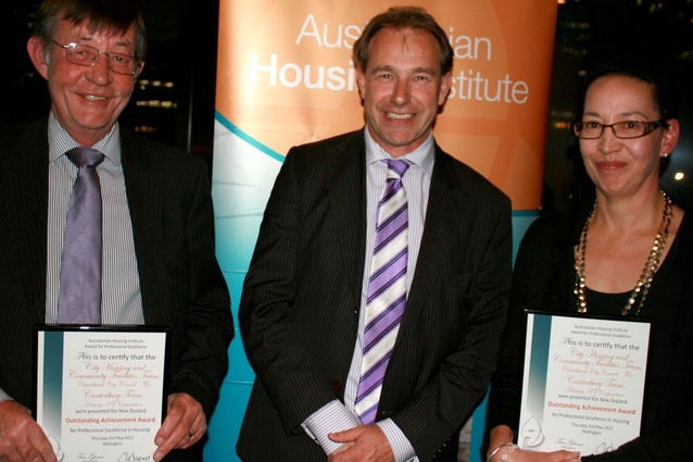Jeanette Gower, Housing New Zealand, and Kevin Bennett, Christchurch City Council, receiving the Outstanding Achievement Award from Housing Minister Phil Heatley (centre).