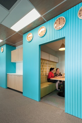 Timber slat walls in Resene Scooter give a multi-purpose acoustic room and quiet meeting booths a retro Kiwi caravan feel. 